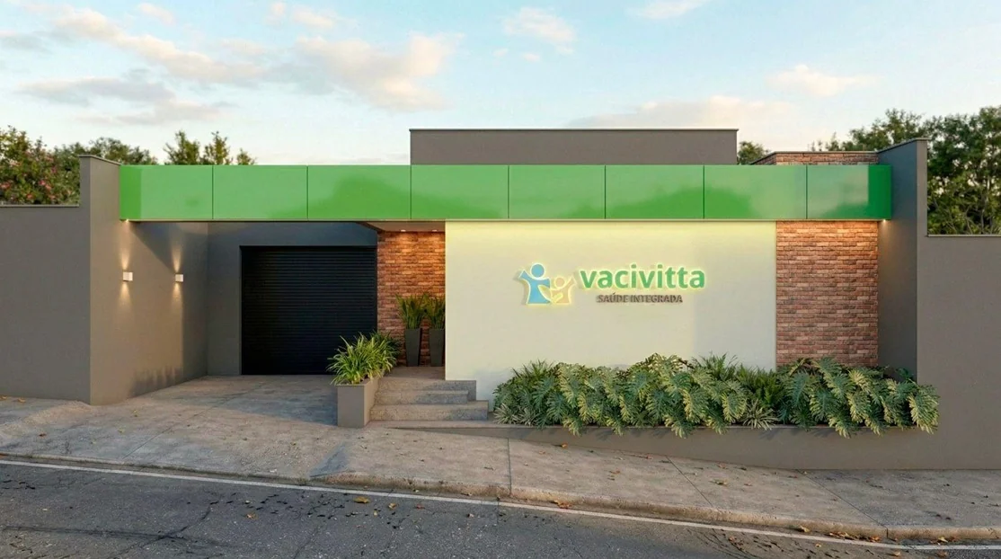 Fachada da unidade Betim da Vacivitta, com parede verde, tijolos e jardim.